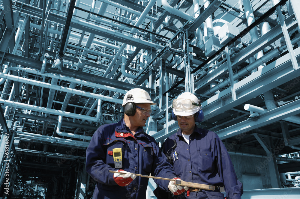 oil workers inside large refinery industry oil workers inside large refinery industry