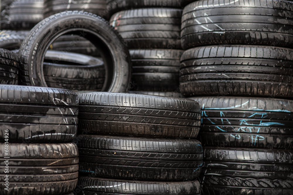 Car tyres stacked in a tyre distribution centre Car tyres stacked in a tyre distribution centre