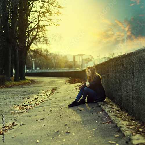 Lonely girl in the city at sunset