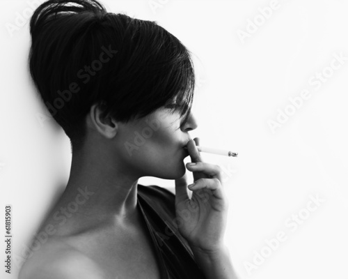 Close-up portrait in profile of a girl with a cigarette