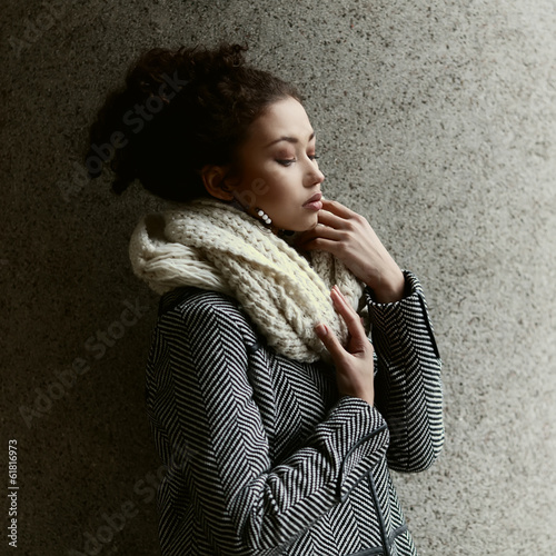 Beautiful fashionable black girl posing in a winter coat