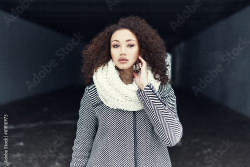 Beautiful fashionable black girl posing in a winter coat
