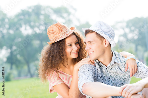 couple lying on the grass in the summer park