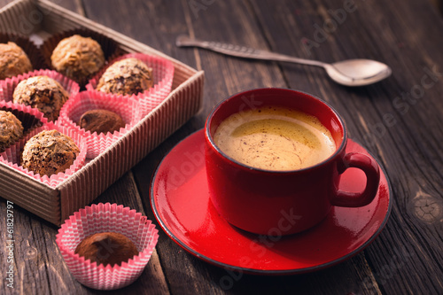 Coffee cup and truffles on table