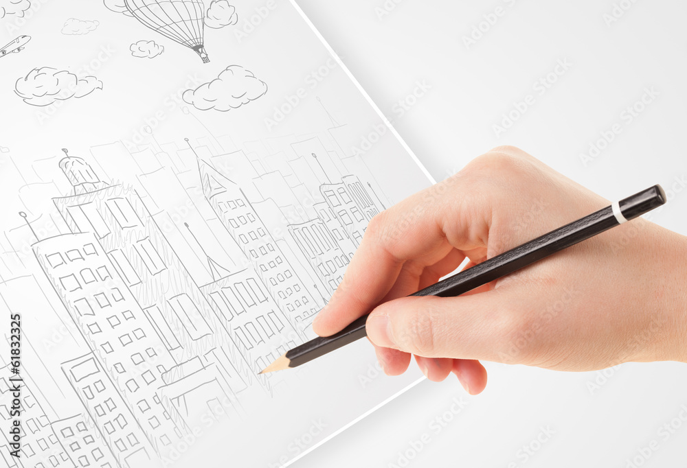 A person drawing sketch of a city with balloons and clouds on a A person drawing sketch of a city with balloons and clouds on a