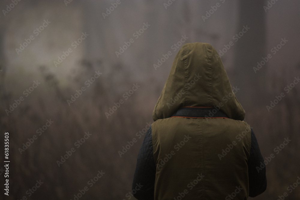 strange person walking in a dark foggy forest strange person walking in a dark foggy forest