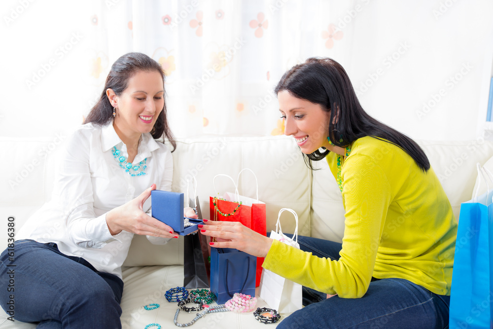 Two women friends at home with shopping bags and jewelry Two women friends at home with shopping bags and jewelry