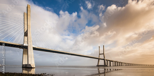 Vasco da Gama Bridge over the Tagus river at sunrise with cloudy