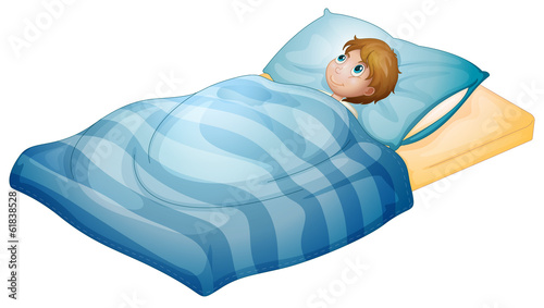 A boy lying in his bed