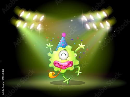 A green monster in the middle of the stage