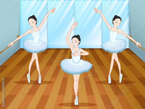 Three ballet dancers dancing inside the studio