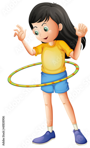 A young girl playing with a hulahoop