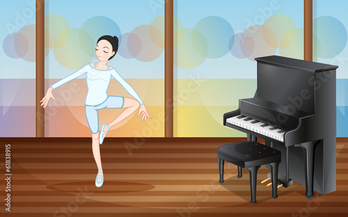 A ballet dancer inside the studio with a piano