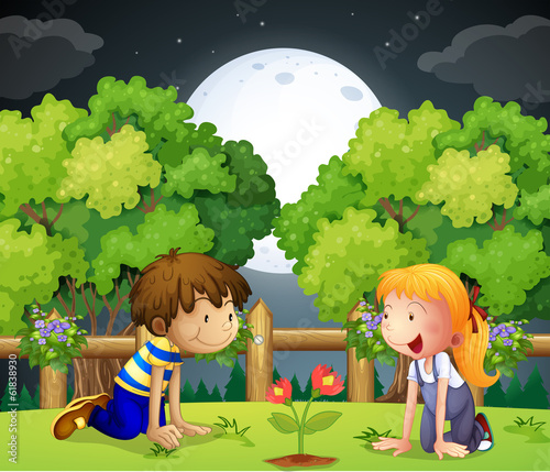 Two kids watching the growing plant