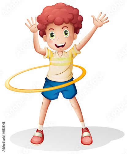 A young boy playing with the hulahoop