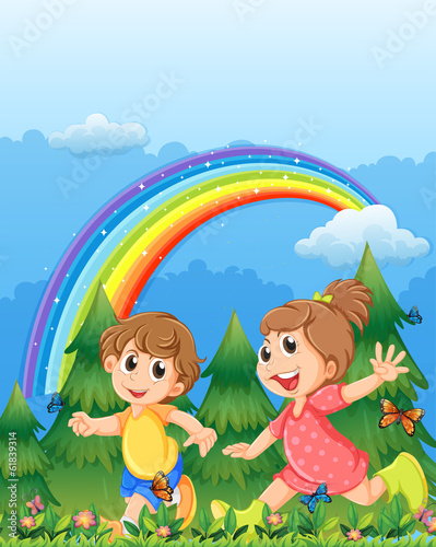 Kids playing near the garden with a rainbow in the sky