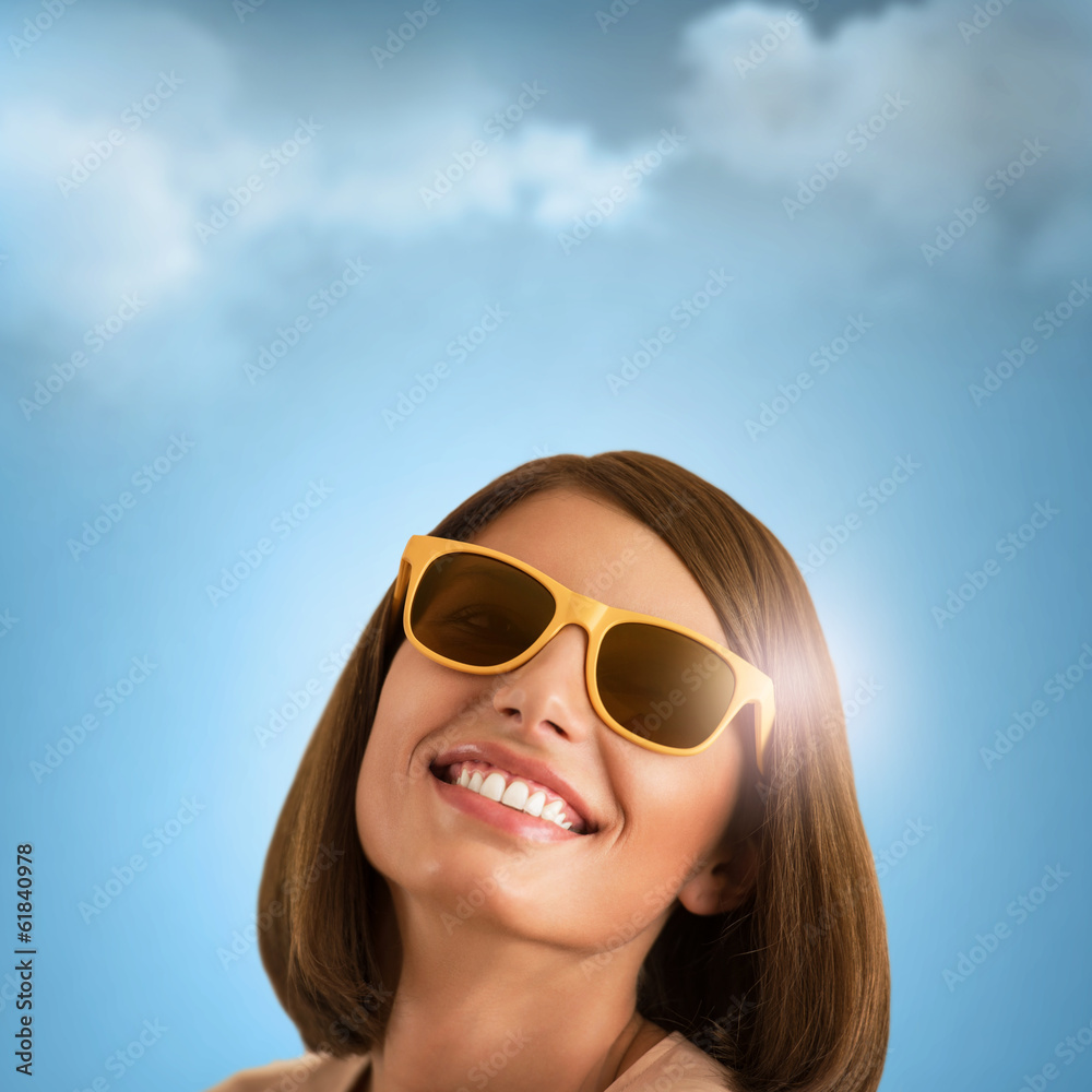 Happy young woman posing over blue sky Happy young woman posing over blue sky