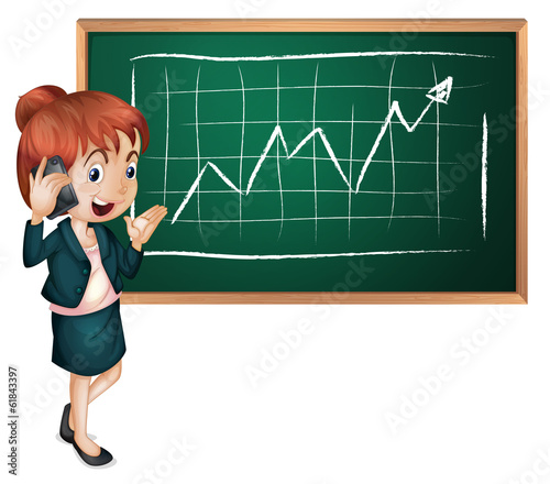 A lady using her cellular phone in front of the blackboard