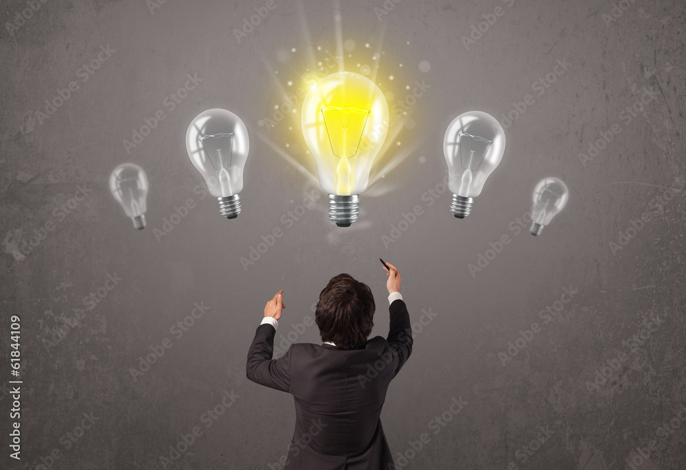 Business person having an idea light bulb concept Business person having an idea light bulb concept