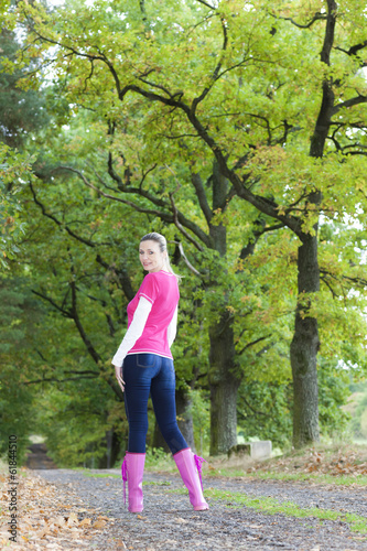 woman wearing rubber boots in alley