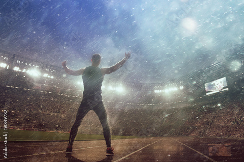 Image of muscle man posing on stadium