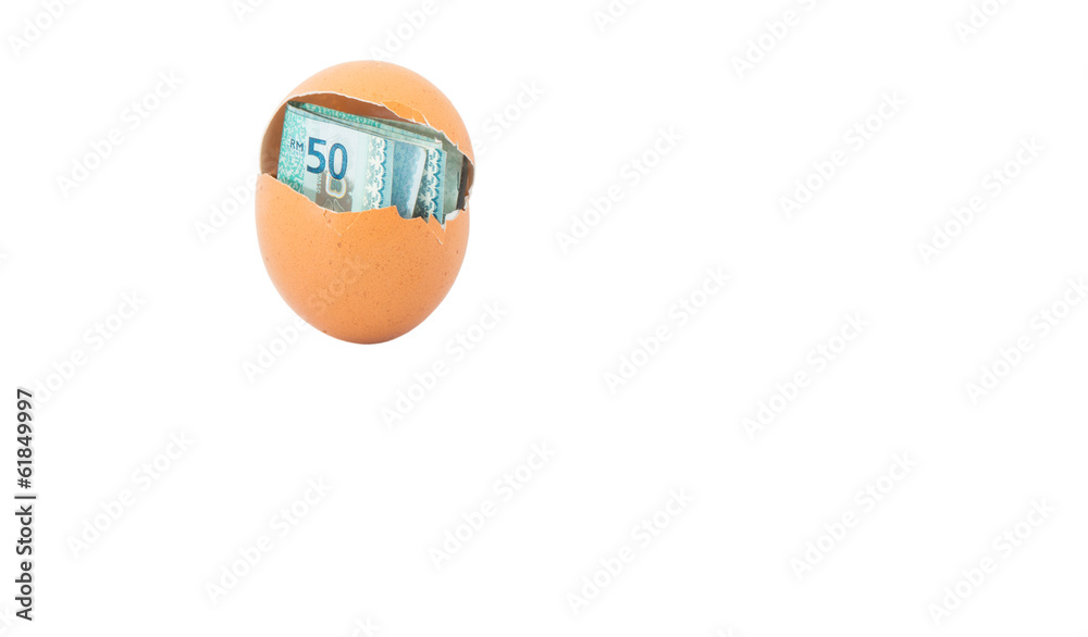 Concept image of Malaysia currency inside chicken egg over white Concept image of Malaysia currency inside chicken egg over white