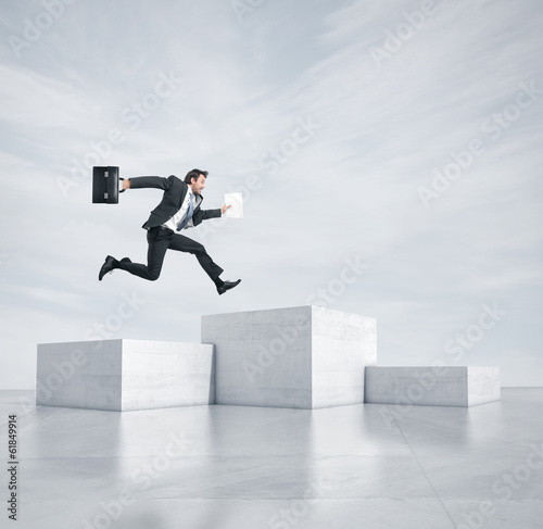 Fotografie Businessman jumping to highest cube