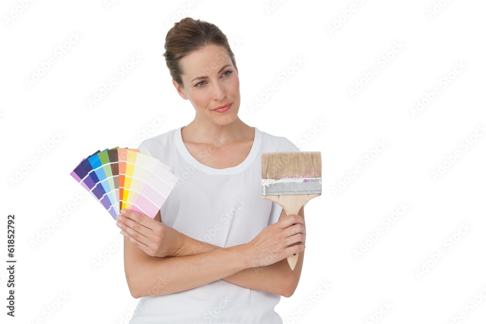 Young woman with paint samples and paintbrush Young woman with paint samples and paintbrush