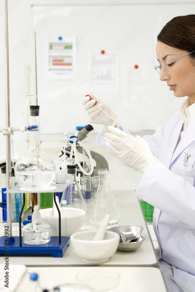 Fototapeta premium female researcher conducting experiment