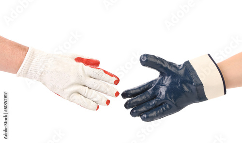 Two hands gloves meet in hand shake.
