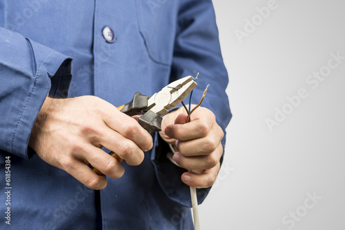 Electrician repairing an electrical cable