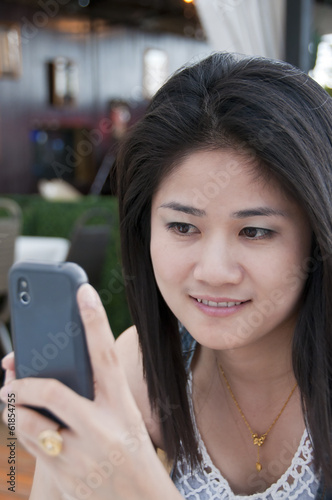 Beautiful Asian woman using mobile phone.