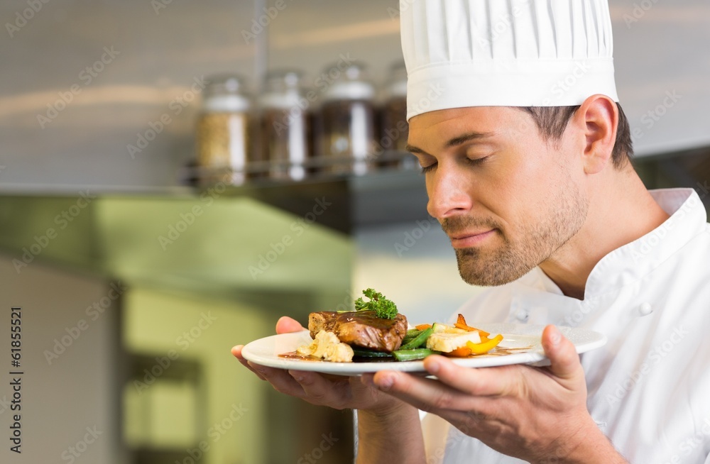Male chef with eyes closed smelling food Male chef with eyes closed smelling food