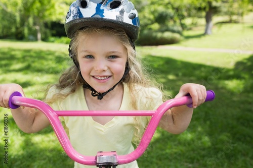 Close-up of little girl on a bicycle at park