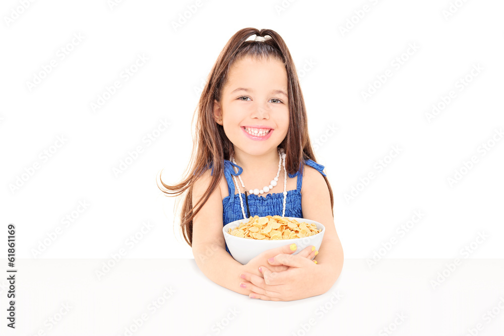 Cute little girl holding a bowl of cereal Cute little girl holding a bowl of cereal