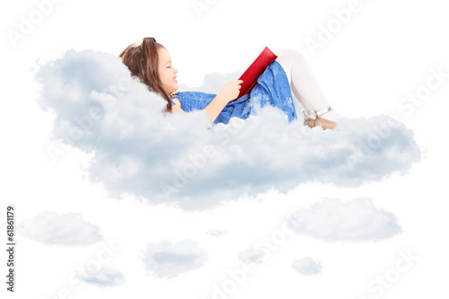 Cute little girl reading a book and laying on cloud