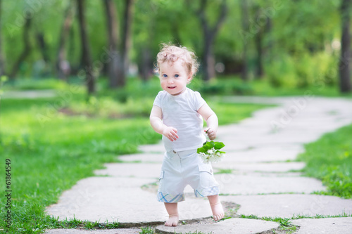 Beautiful baby girl walking in the park