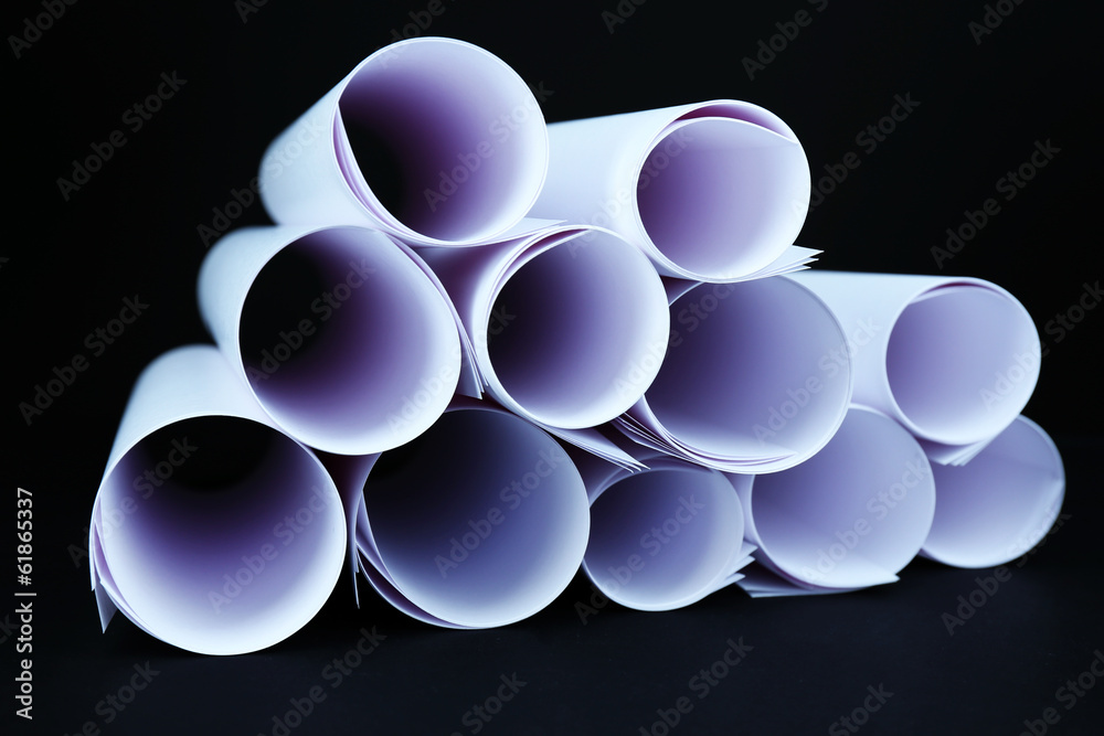 White paper rolls on black background close-up White paper rolls on black background close-up