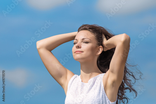 Portrait of young woman on background of sky © azazello