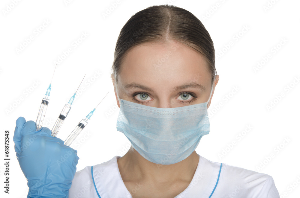 Doctor in mask holding three syringe Doctor in mask holding three syringe