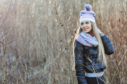 Portrait of attractive young blonde girl in a wood