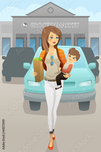 Mother carrying her son and grocery bags