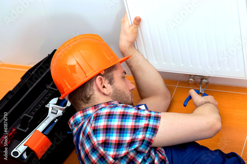 Handy man repairing heater