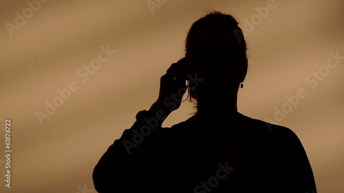 Female silhouette calling on the phone