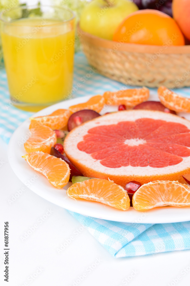 Sweet fresh fruits on plate on table close-up Sweet fresh fruits on plate on table close-up