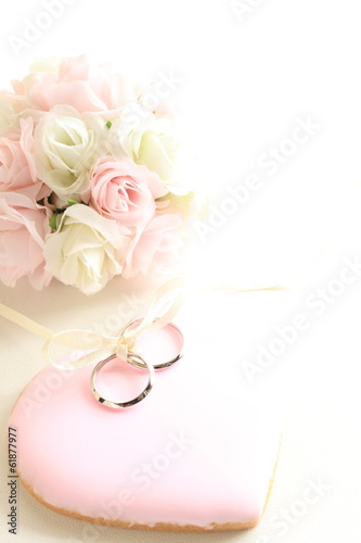 pink icing cookie with wedding rings