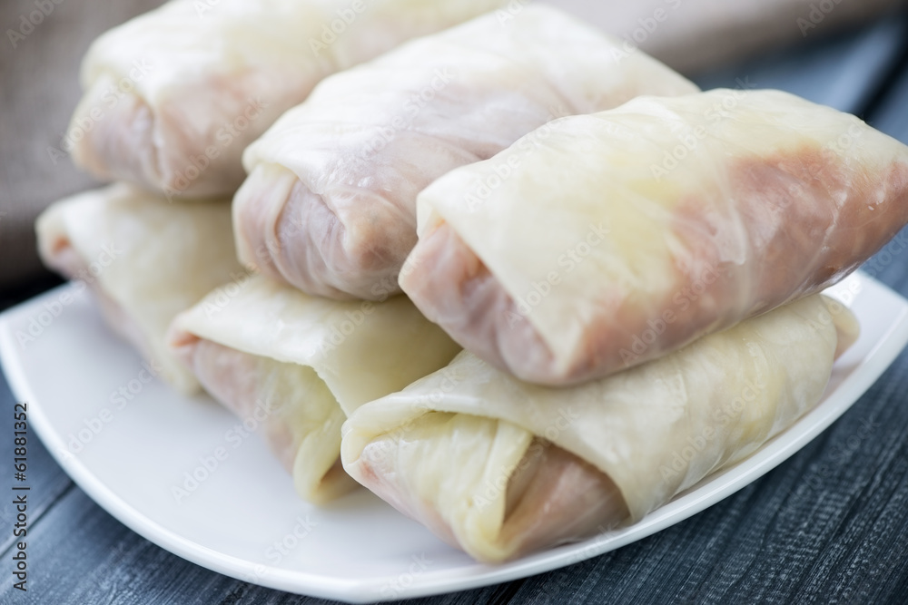 Uncooked cabbage rolls with minced meat and rice, close-up