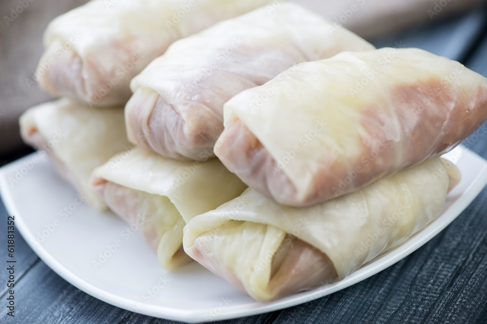Uncooked cabbage rolls with minced meat and rice, close-up Uncooked cabbage rolls with minced meat and rice, close-up
