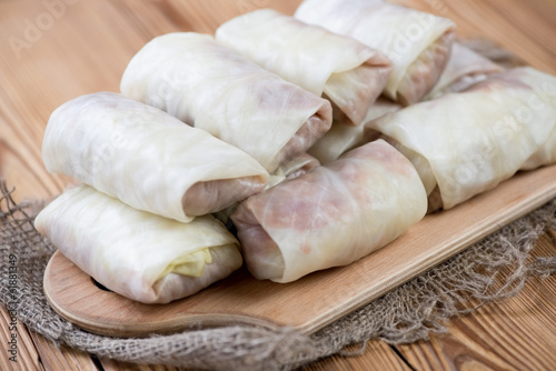 Uncooked cabbage leaves stuffed with meat filling, close-up