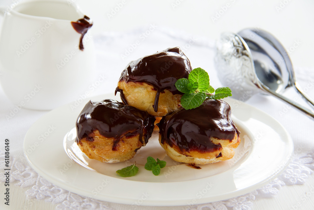 profiteroles with cream and chocolate sauce. profiteroles with cream and chocolate sauce.